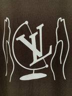 Close-up of white LV-style graphic print on dark brown T-shirt back