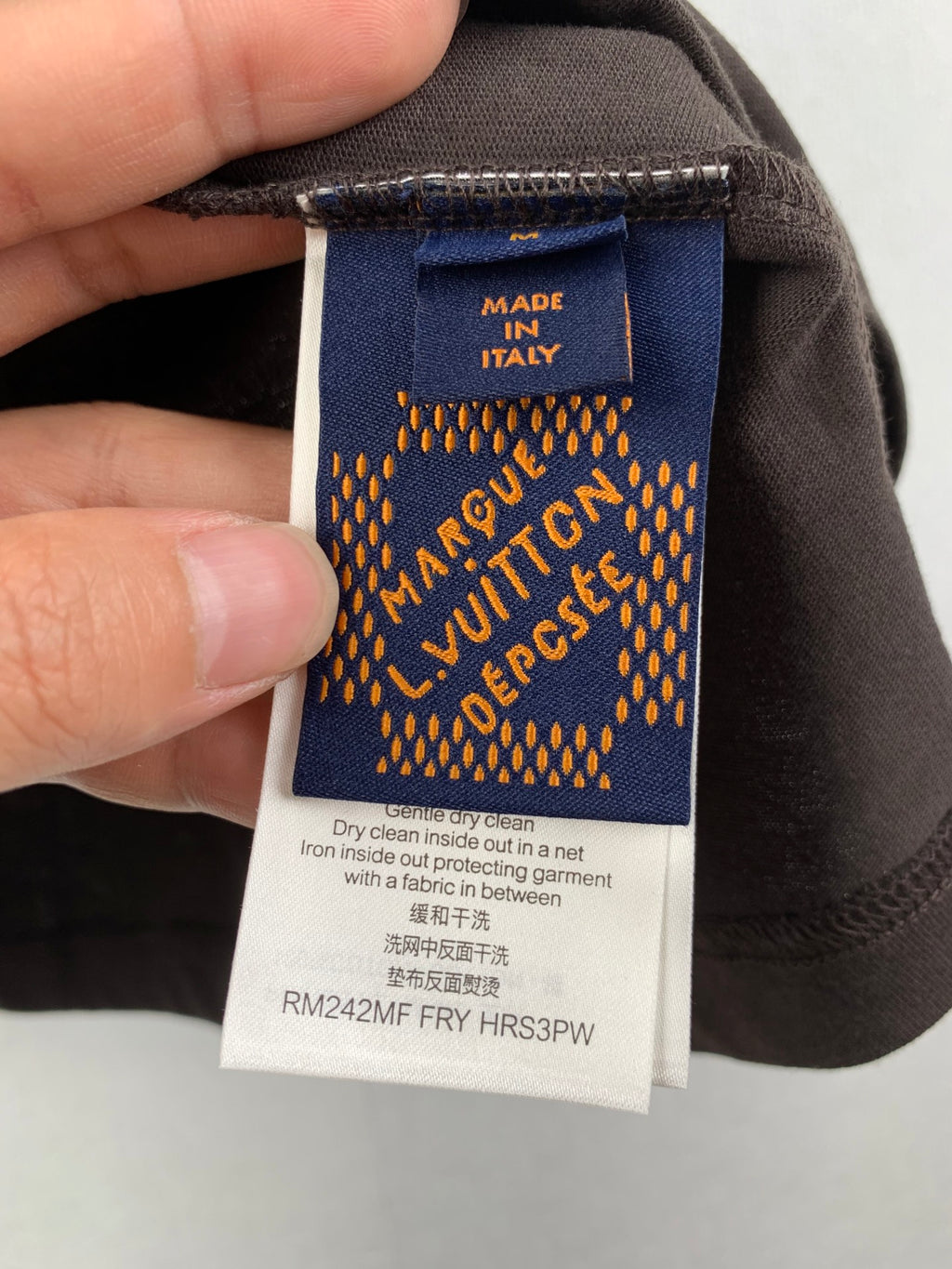 Blue inside care label on dark shorts, marked Made in Italy