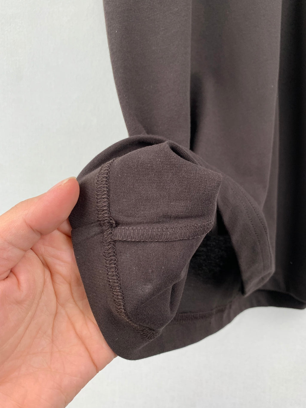 Dark gray shorts cuff with stitched hem and seam detail