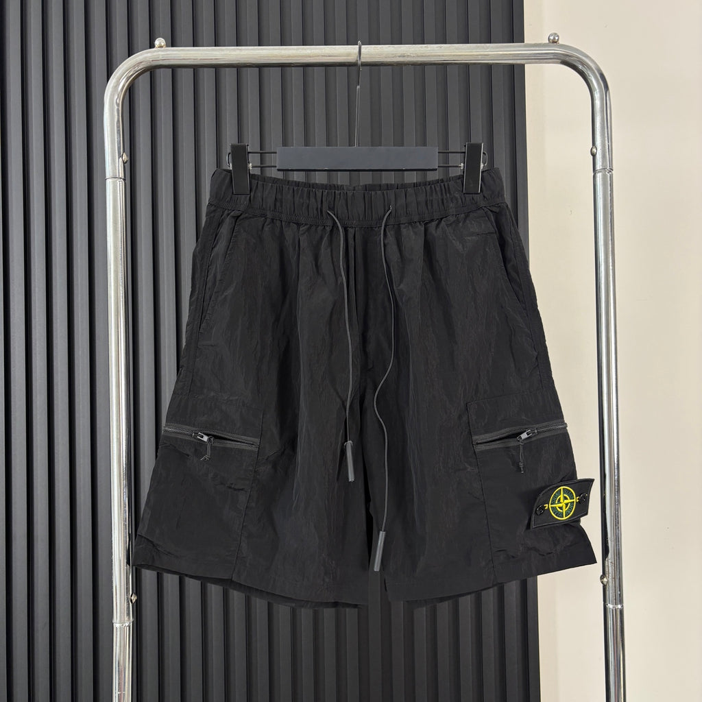 Black cargo shorts with drawstring waist, side pockets, and Stone Island patch