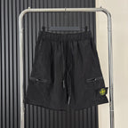 Black cargo shorts with drawstring waist, side pockets, and Stone Island patch
