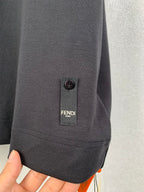 Dark T-shirt sleeve hem with FENDI label and small buttoned tab