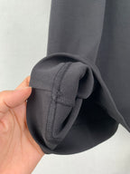 Dark T-shirt sleeve cuff detail with stitched seam