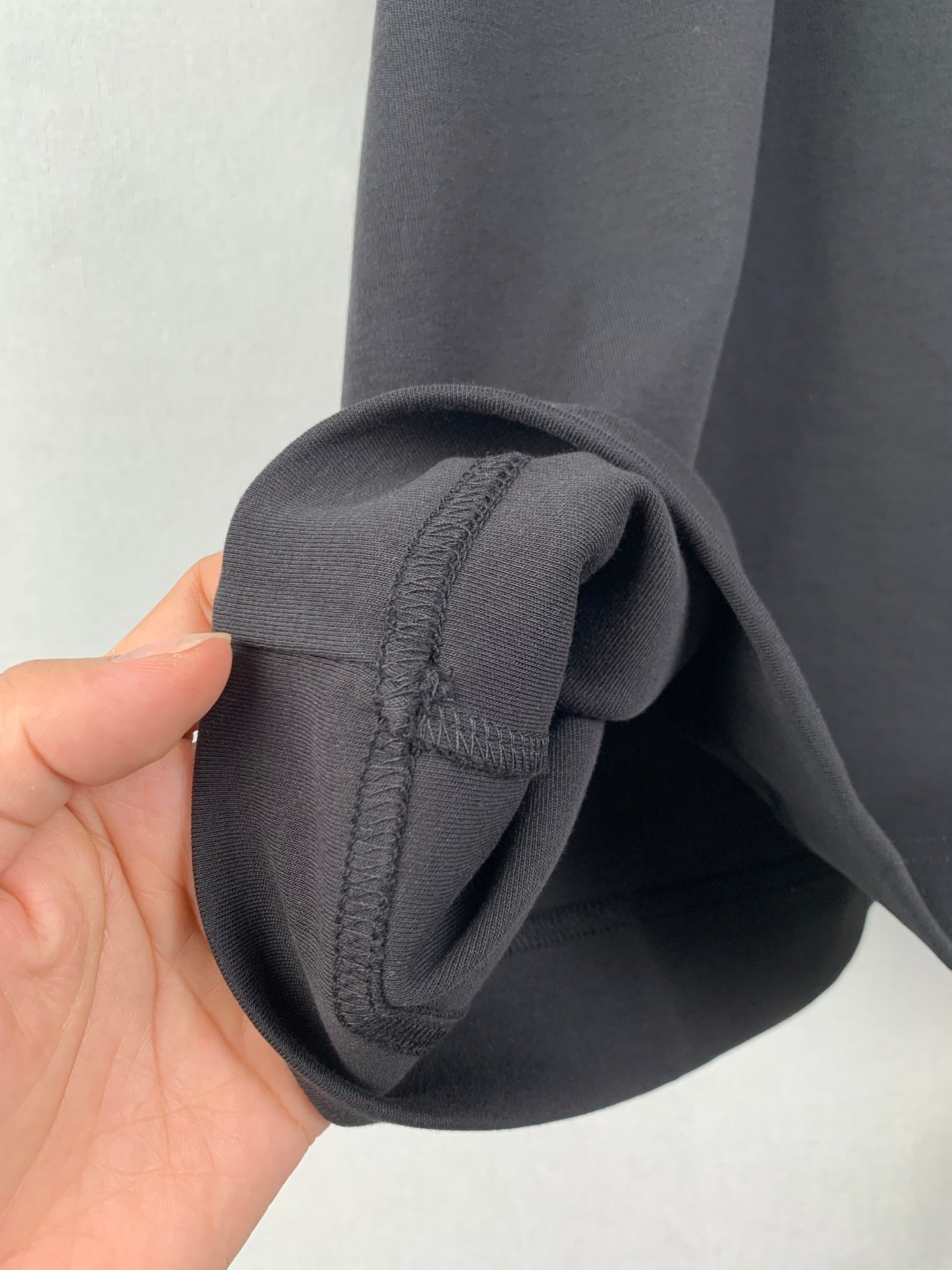 Dark T-shirt sleeve cuff detail with stitched seam