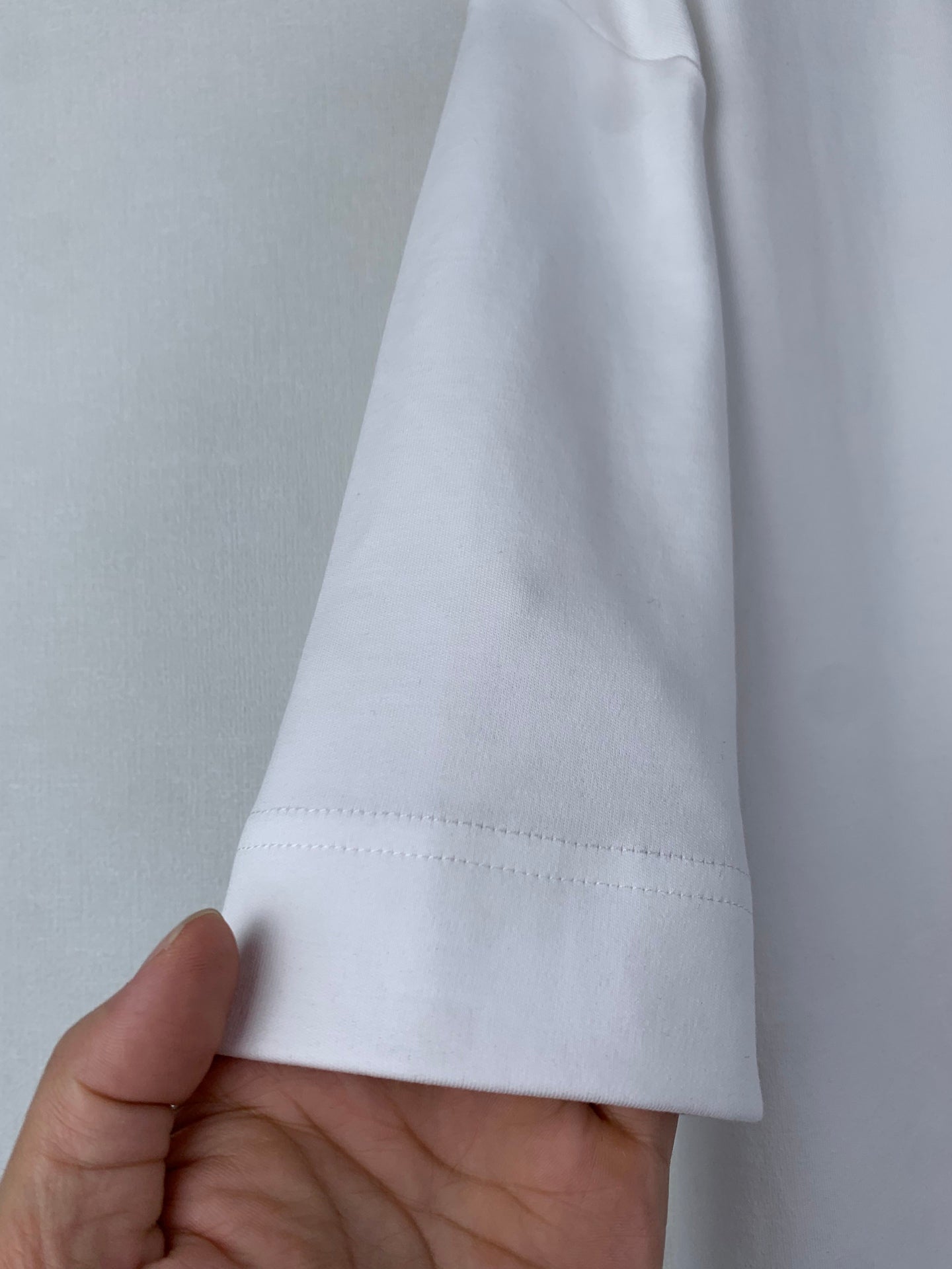 White Fendi T-shirt hem close-up with visible stitching