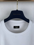 White Fendi T-shirt neckline close-up with Fendi brand label inside collar