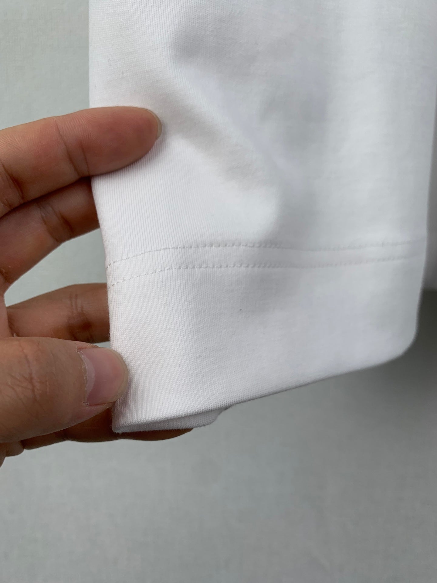 White Fendi T-shirt sleeve cuff seam close-up