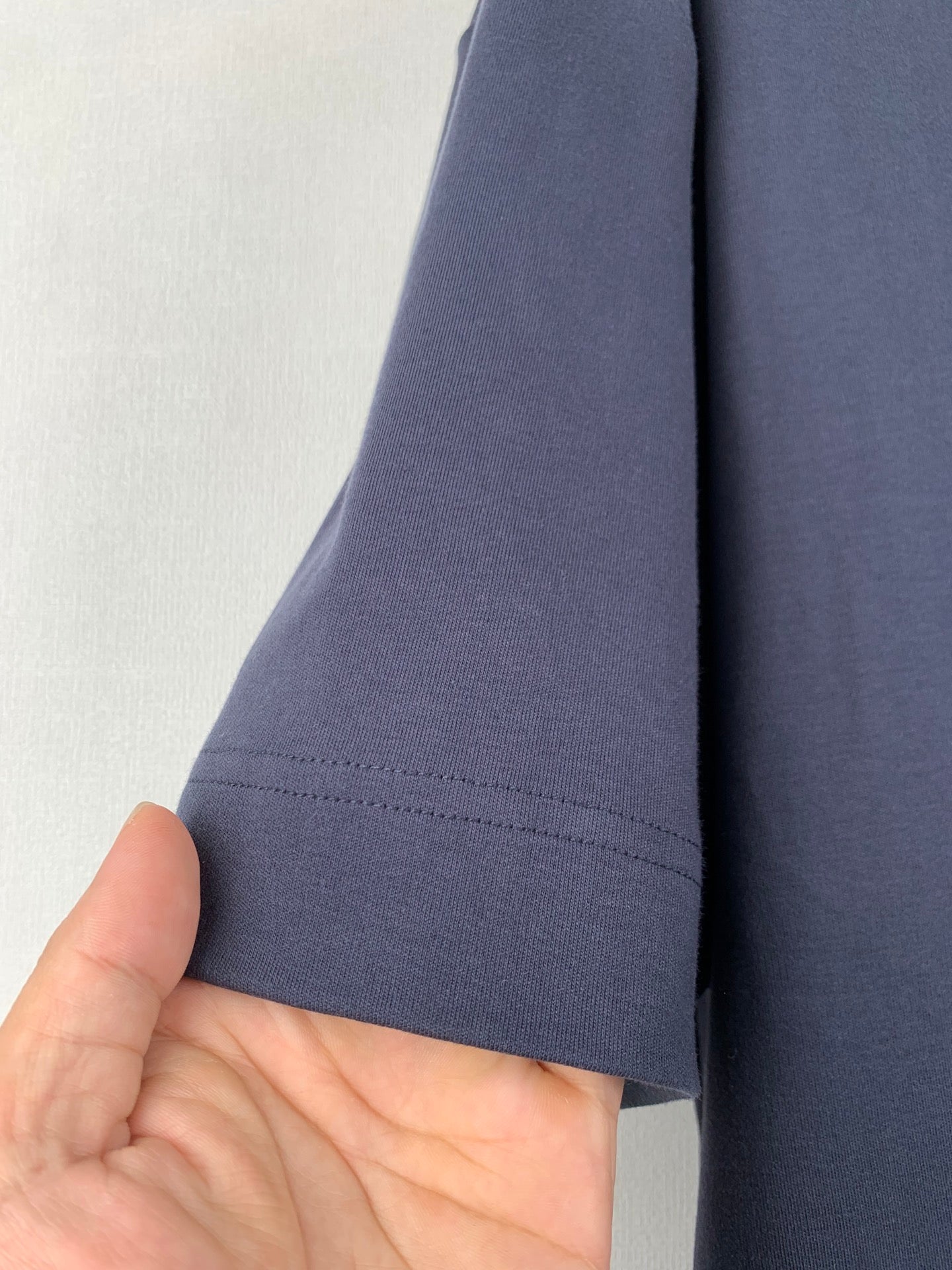 Fendi dark blue T-shirt sleeve with stitched hem, side view