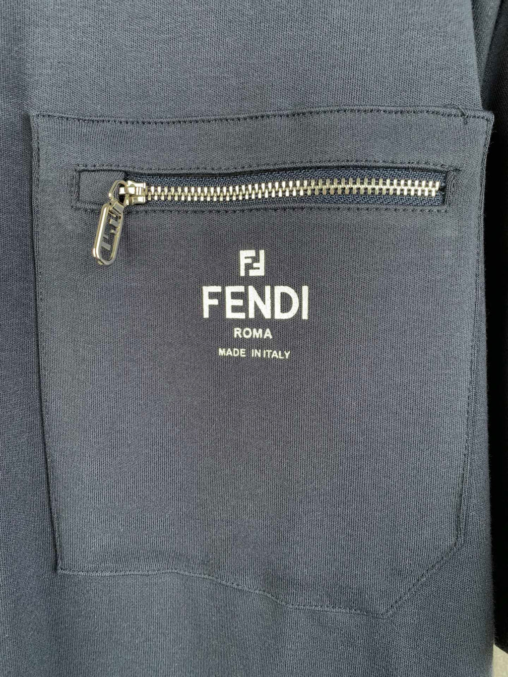 Fendi dark blue chest pocket with gold zipper and Fendi logo patch