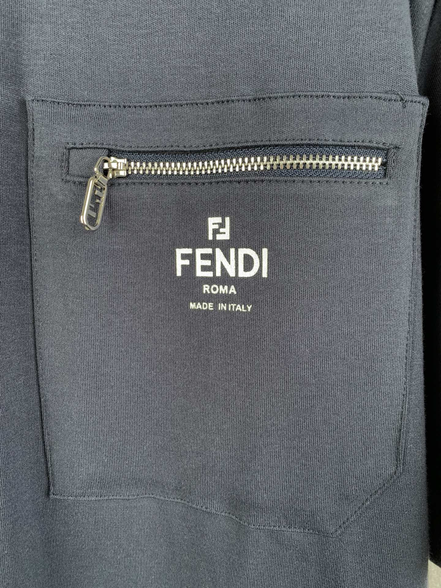 Fendi dark blue chest pocket with gold zipper and Fendi logo patch