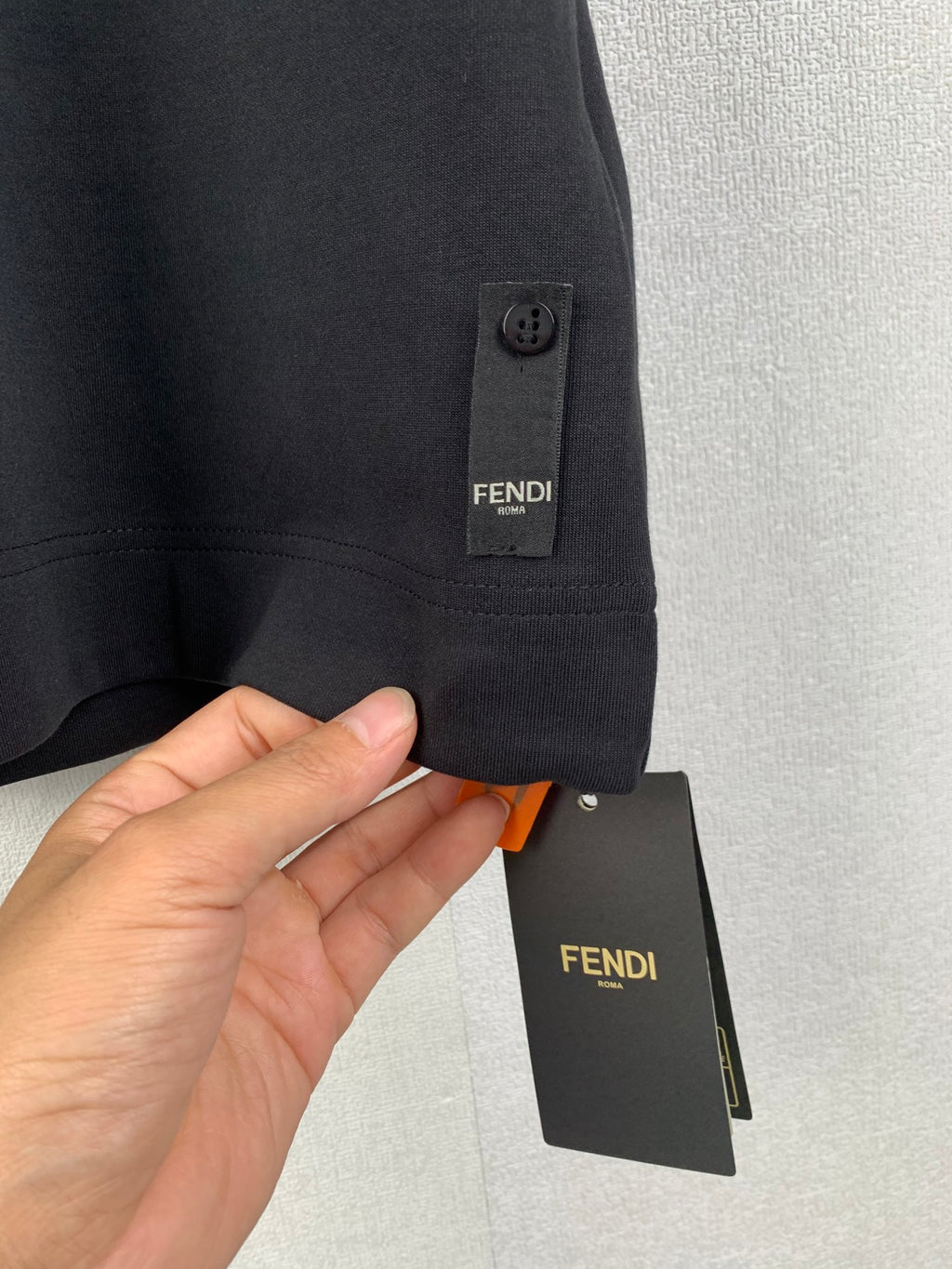 Black Fendi short-sleeve T-shirt with side tab and hanging price tag