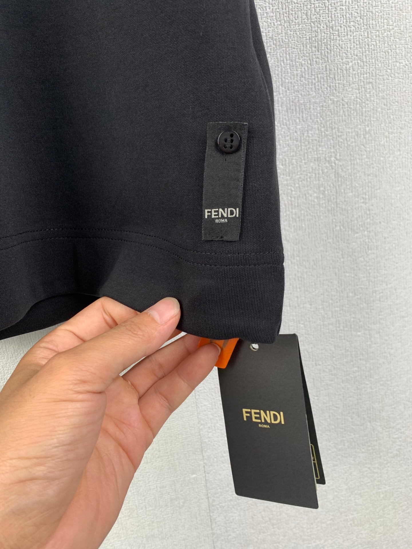 Black Fendi short-sleeve T-shirt with side tab and hanging price tag
