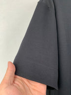 Black short-sleeve T-shirt sleeve hem with visible stitching