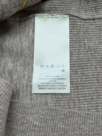 White fabric size label inside heather gray sweater with care icons