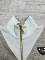 Long-sleeve zip sweater collar with ribbed white neckline and gold zipper pull