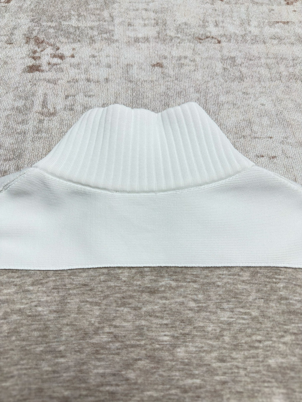 Sweater collar with ribbed white band on heather gray knit body