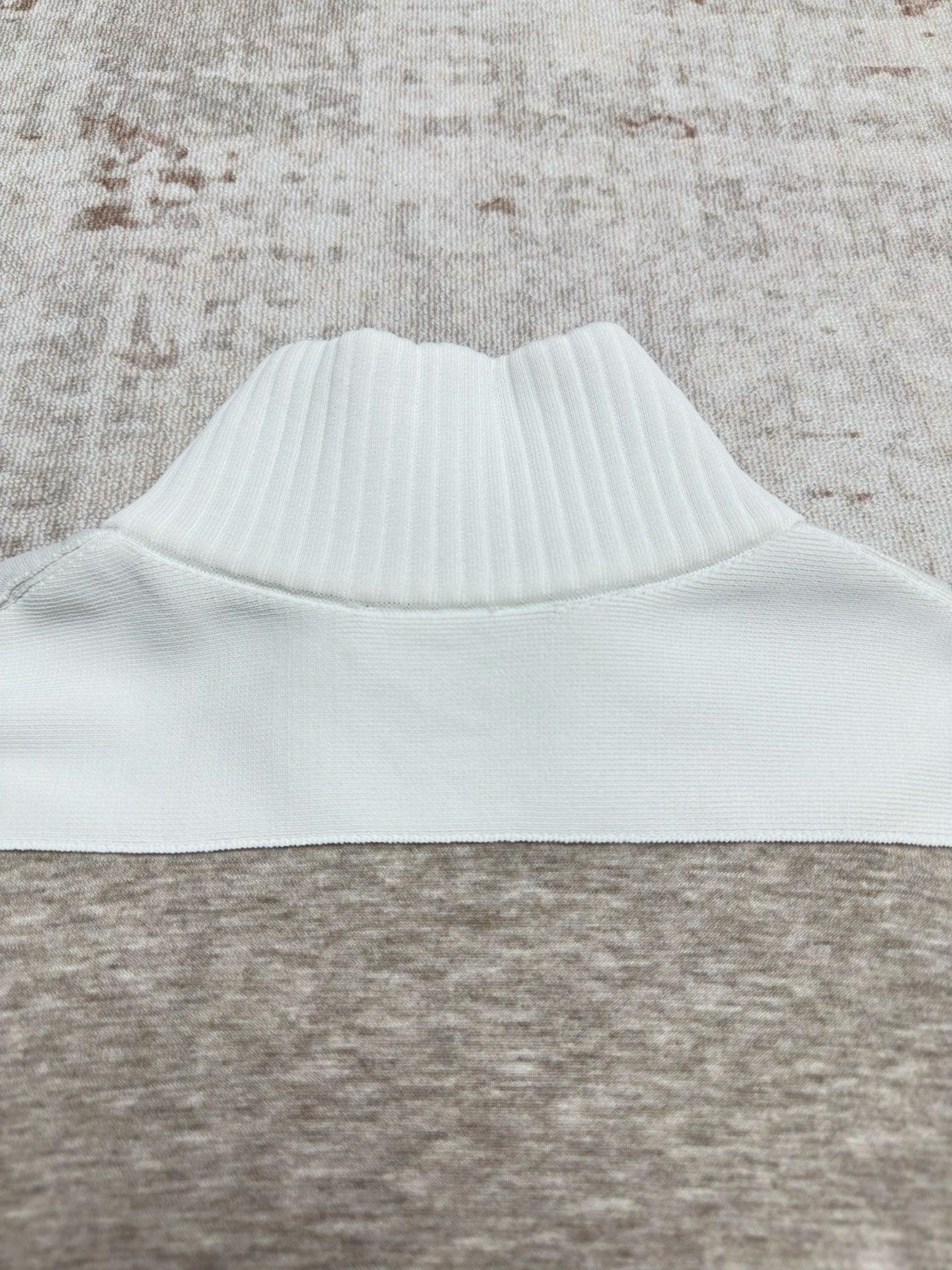 Sweater collar with ribbed white band on heather gray knit body