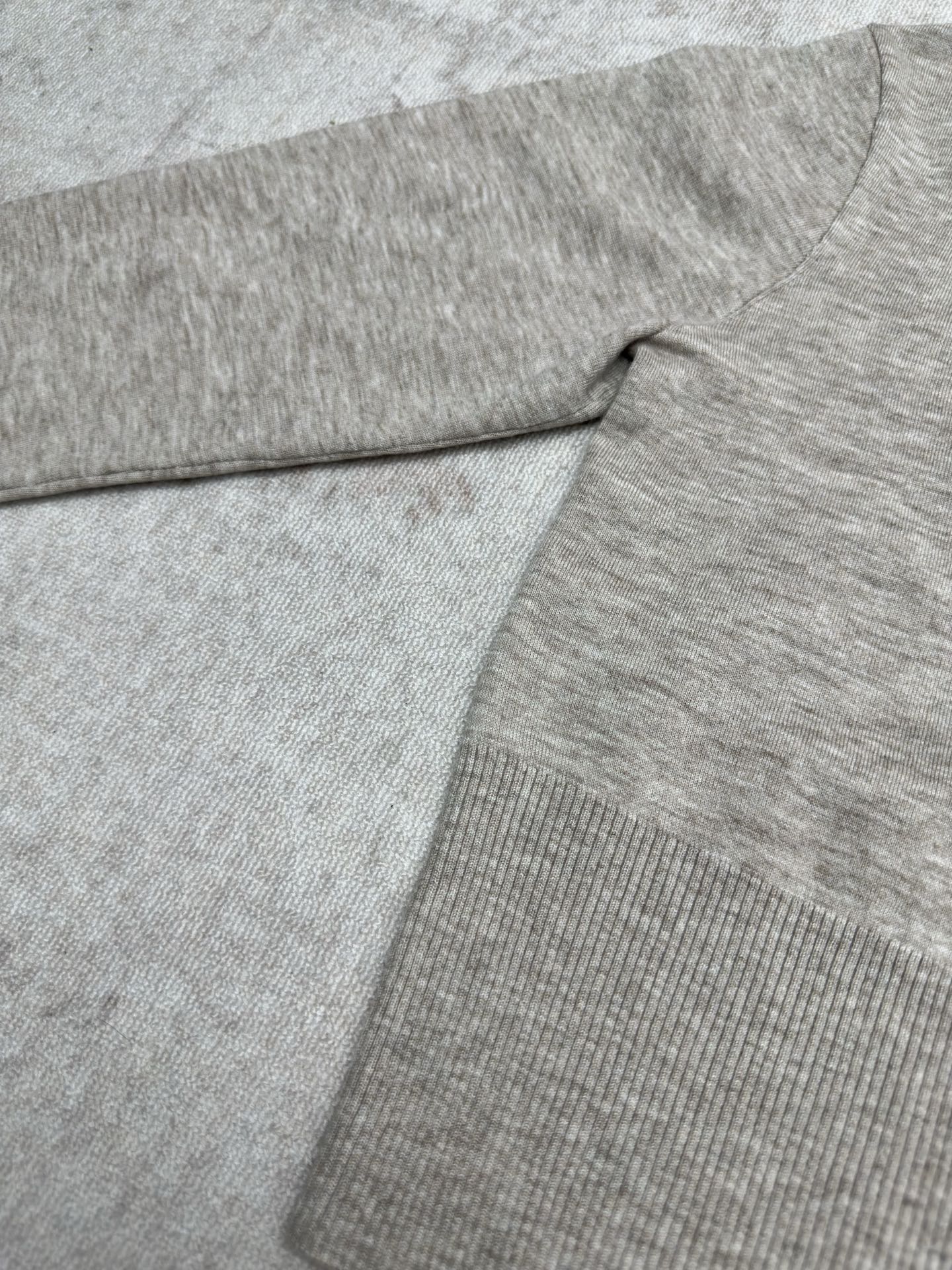 Heather gray long-sleeve sweater with ribbed knit hem and fold detail