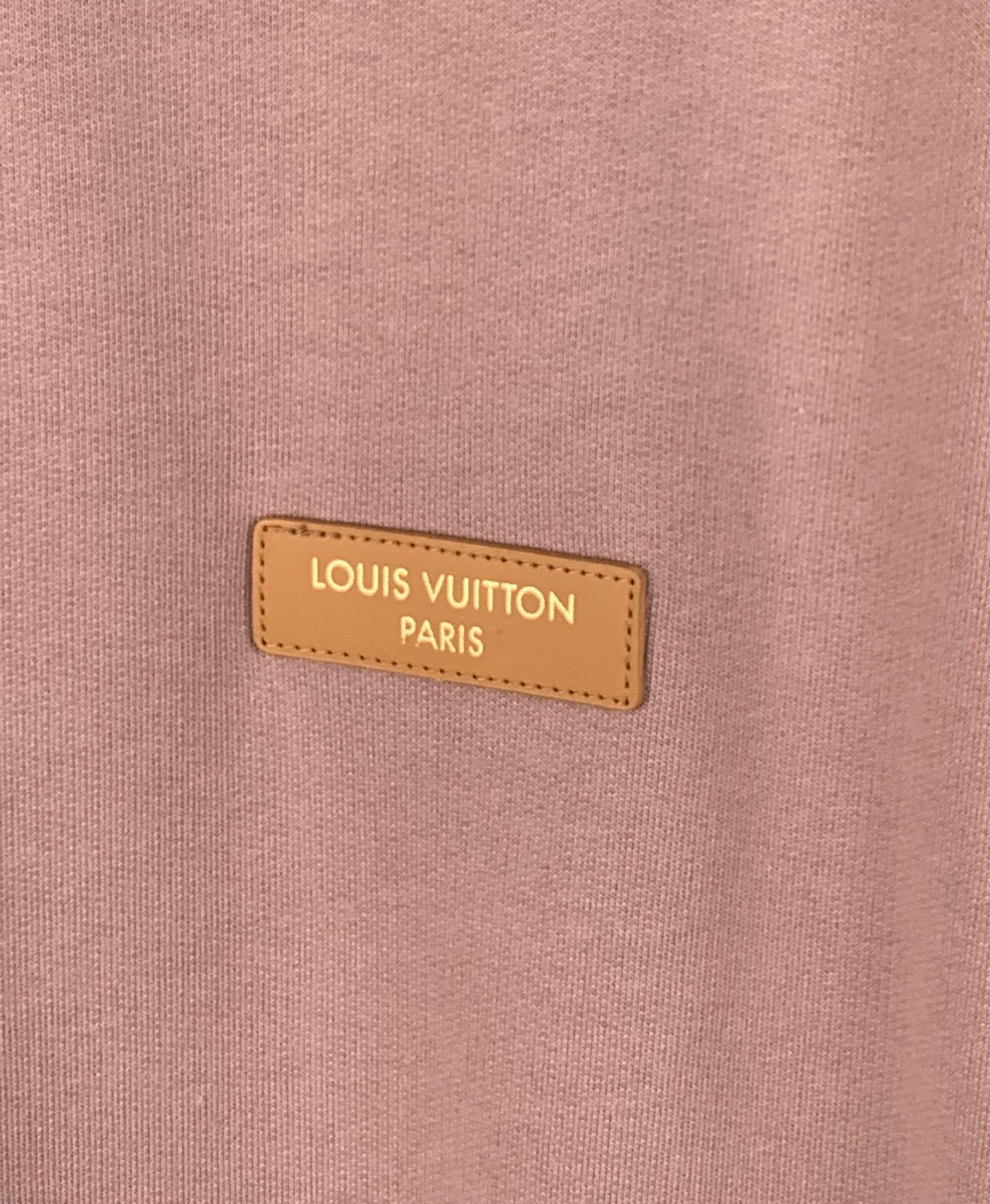 Louis Vuitton Paris logo label on mauve pink sweatshirt chest