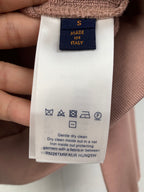 Garment care label on brown fabric long top neckline
