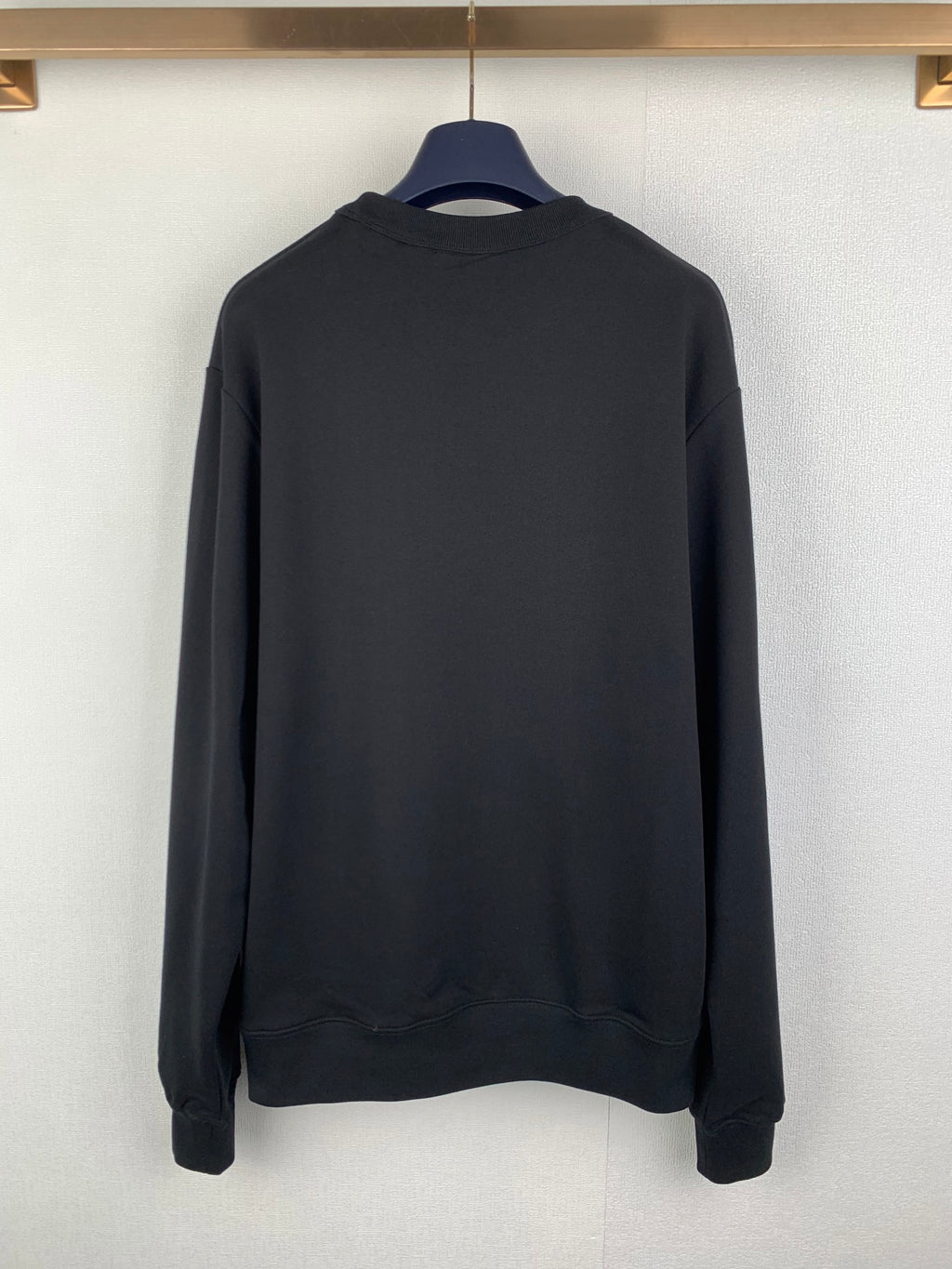 Black crewneck sweatshirt, back view, long sleeves