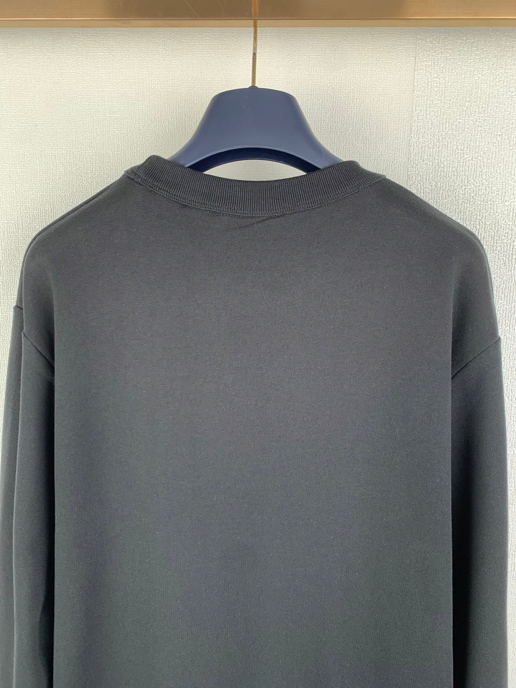 Black crewneck sweatshirt back neckline and upper back