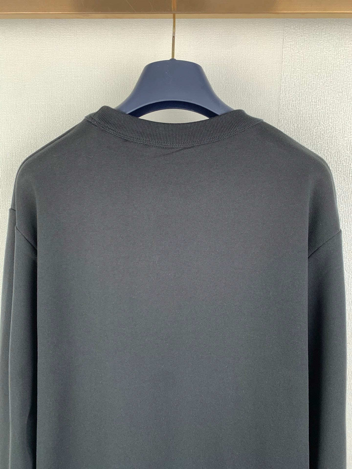 Black crewneck sweatshirt back neckline and upper back