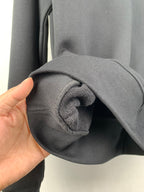 Black sweatshirt cuff detail with rolled sleeve edge