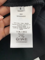 Long garment interior white care and size label with barcode and QR text