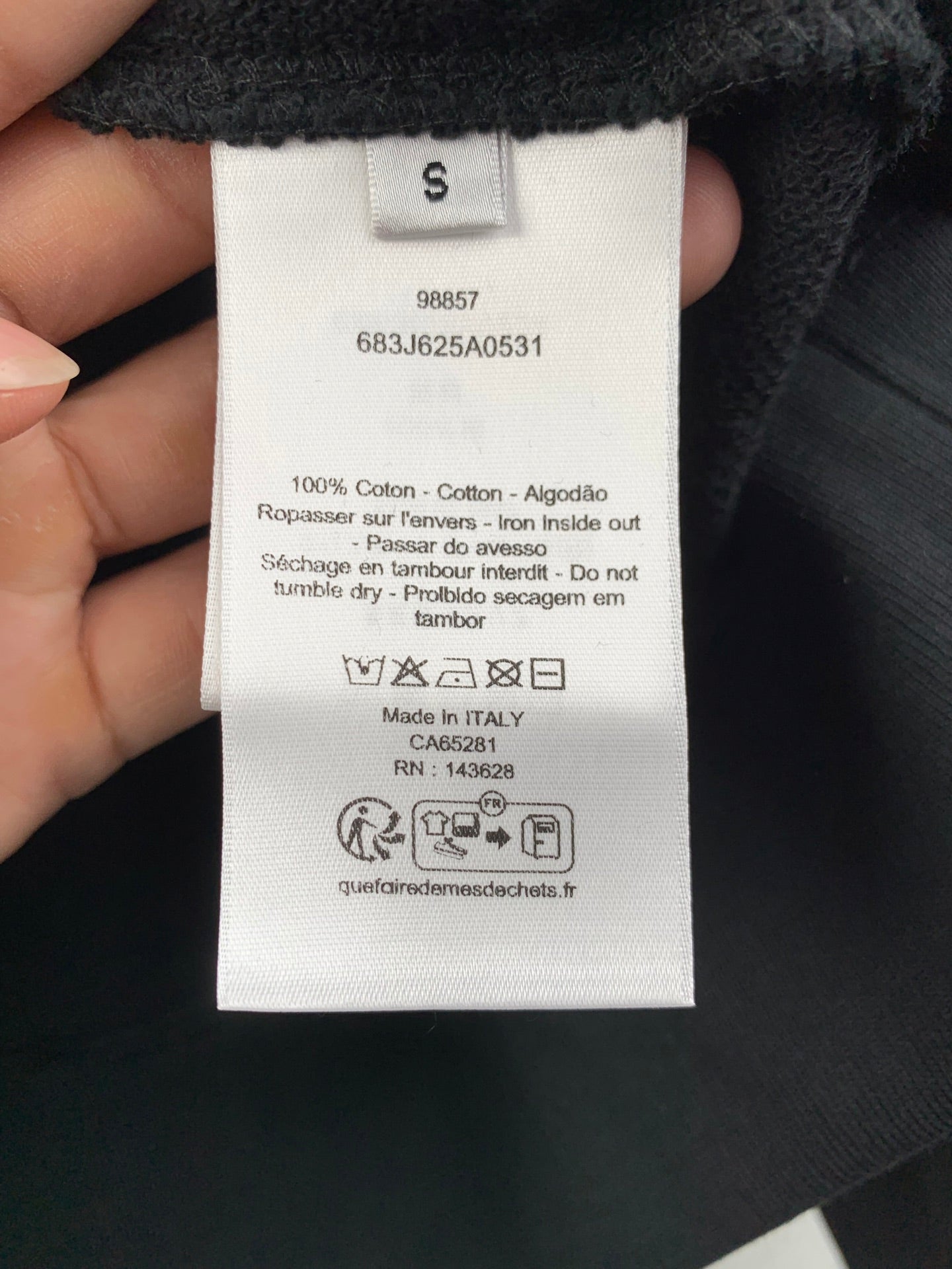 Long garment interior white care and size label with barcode and QR text