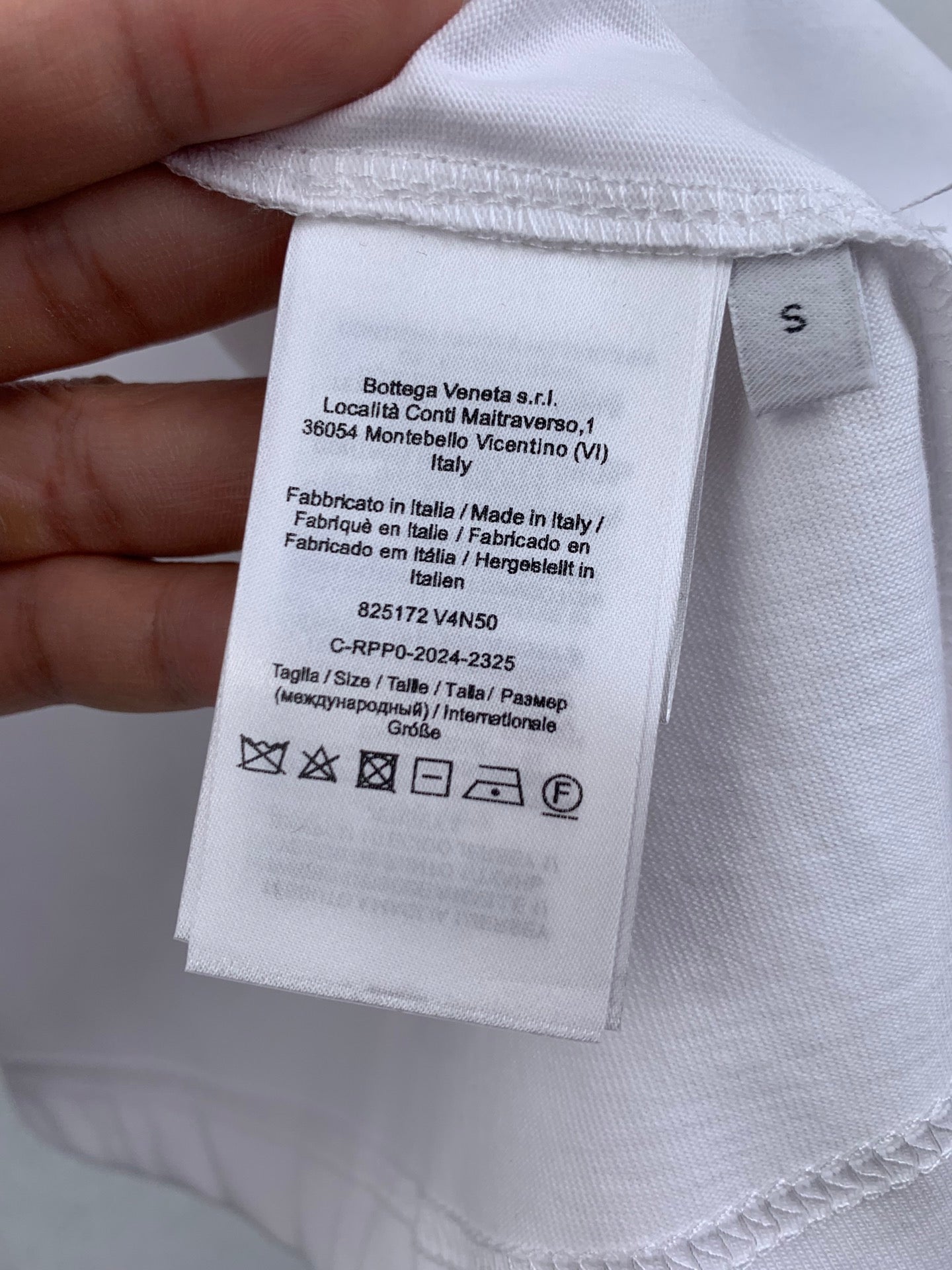 Off white T-shirt care label and size tag on inside neckline