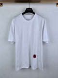 Off white crew-neck T-shirt with small red and blue logo at left chest