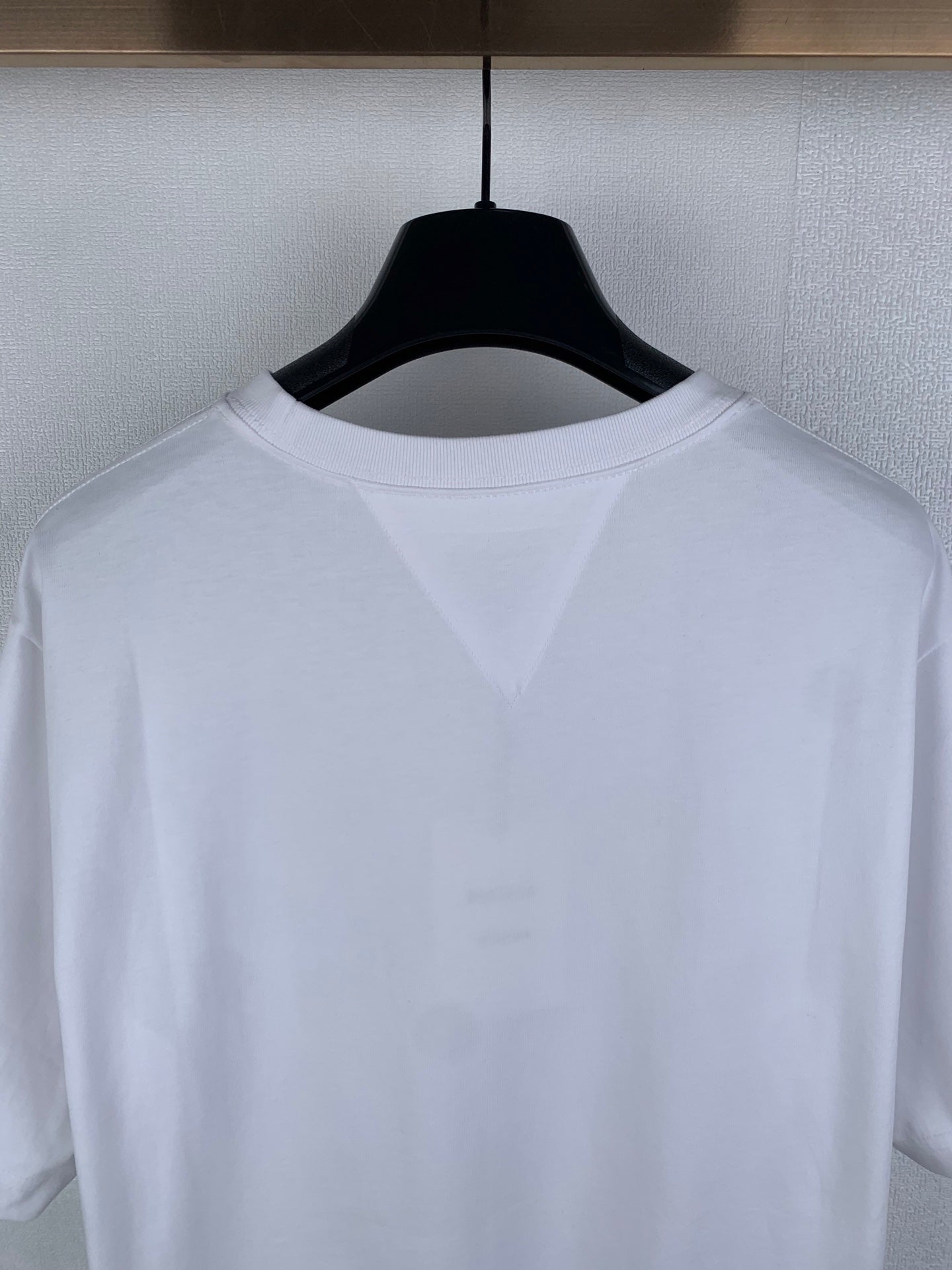 Off white crew-neck T-shirt upper back close-up