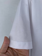 Off white T-shirt hem with double-stitched edge, side view