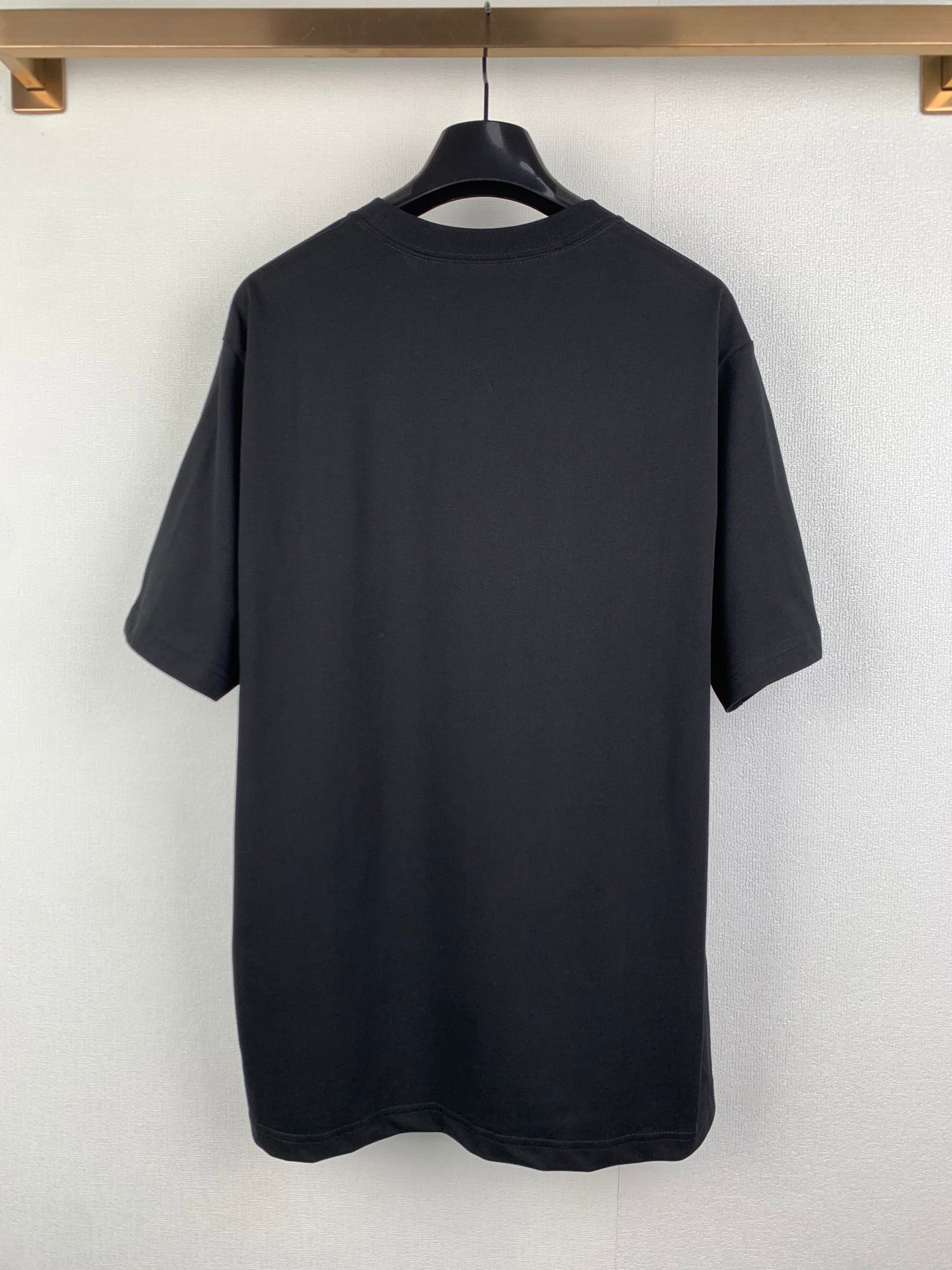Back view short-sleeve crewneck T-shirt in dark charcoal, plain with no visible print
