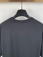 Crewneck T-shirt collar detail in dark charcoal with reinforced stitching at neckline
