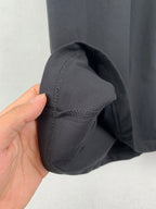 Short-sleeve cuff close-up with dark charcoal stitching and seam