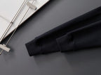 Black sweatshirt sleeve cuff and hem detail, shown folded on a hanger.