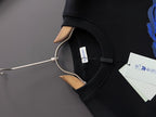 Black sweatshirt hooded neck opening with small white interior tag.