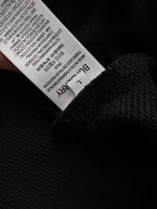 Black sweatshirt with white size label inside the neck opening.