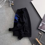 Black sweatshirt side/back view with partial blue horse graphic and tag.