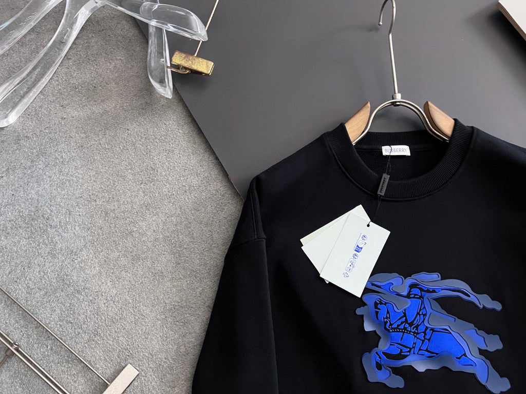 Black sweatshirt neckline with hanging tag and blue horse graphic at chest.
