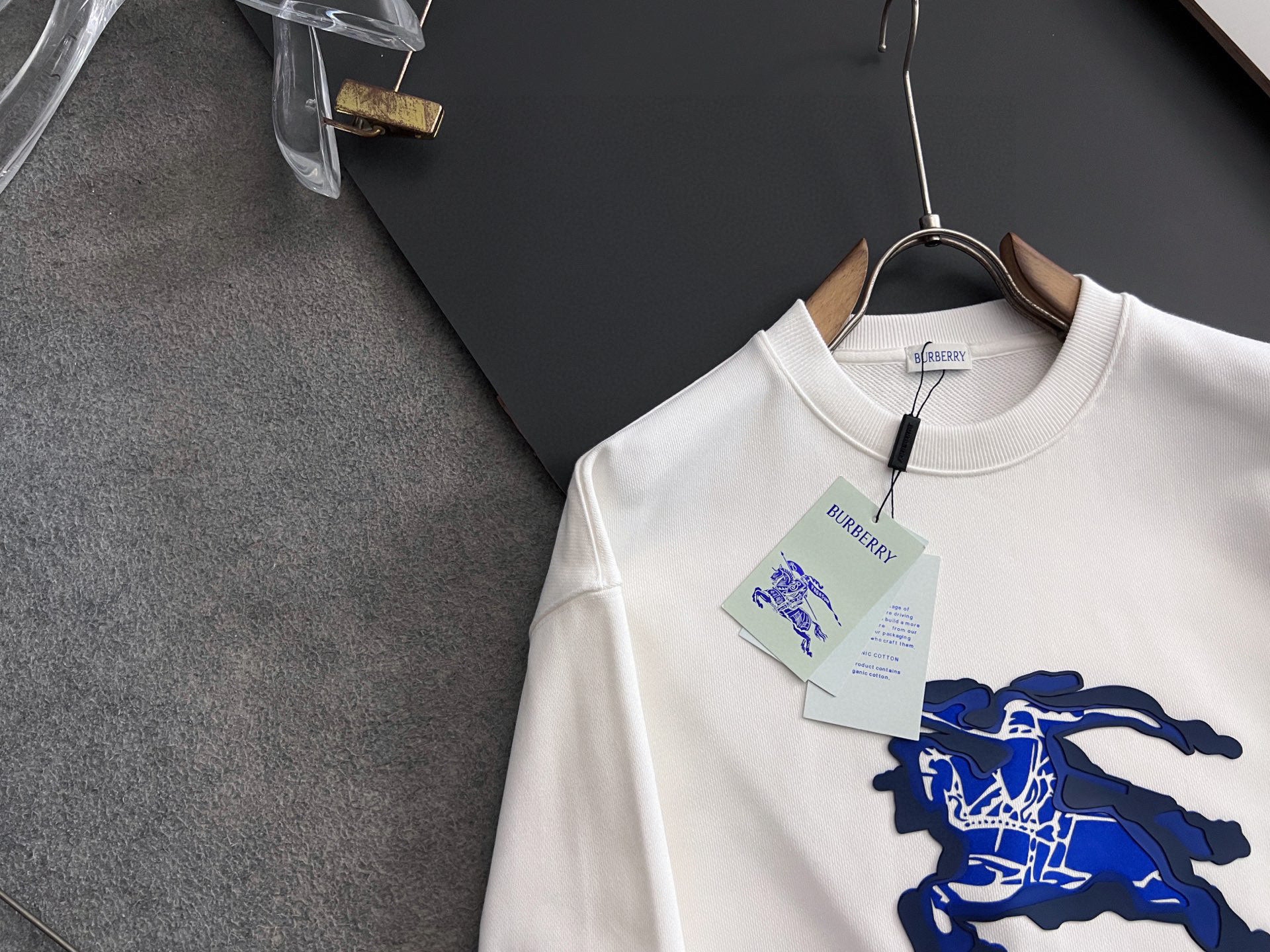 White long-sleeve sweatshirt with blue horse graphic and Burberry branding at neckline