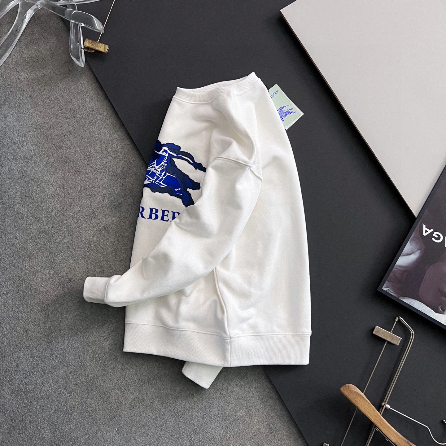 White long-sleeve sweatshirt with blue logo on the side, front view