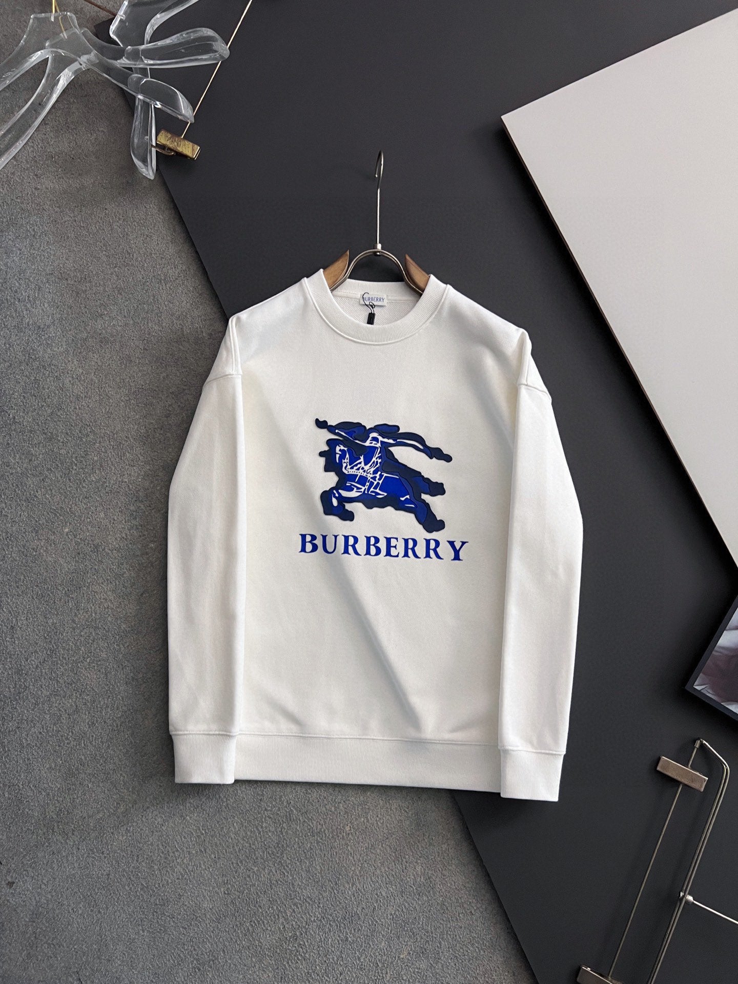 White long-sleeve sweatshirt with blue horse-and-text Burberry logo on chest