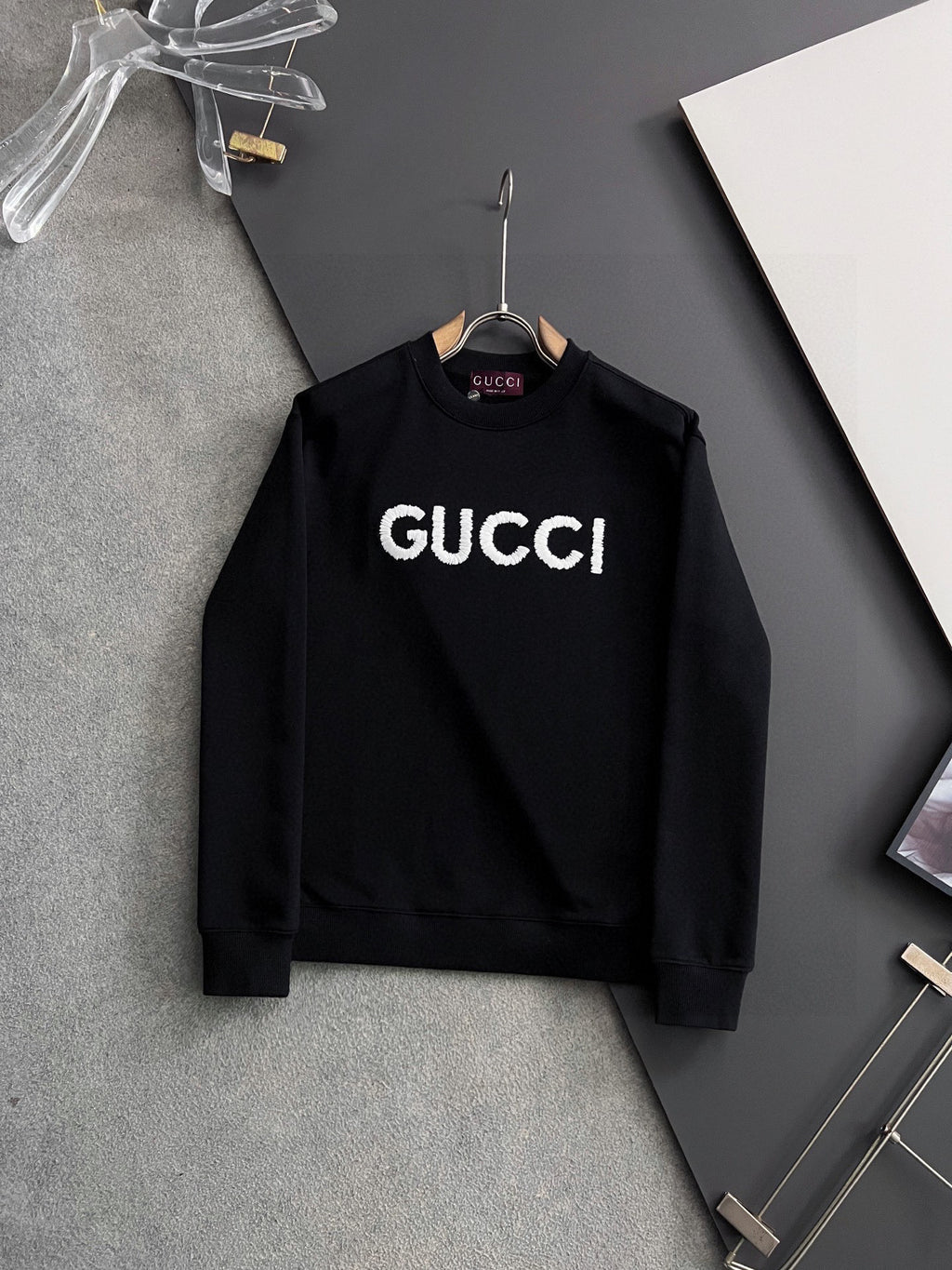 Black Gucci crewneck sweatshirt with white “GUCCI” logo lettering
