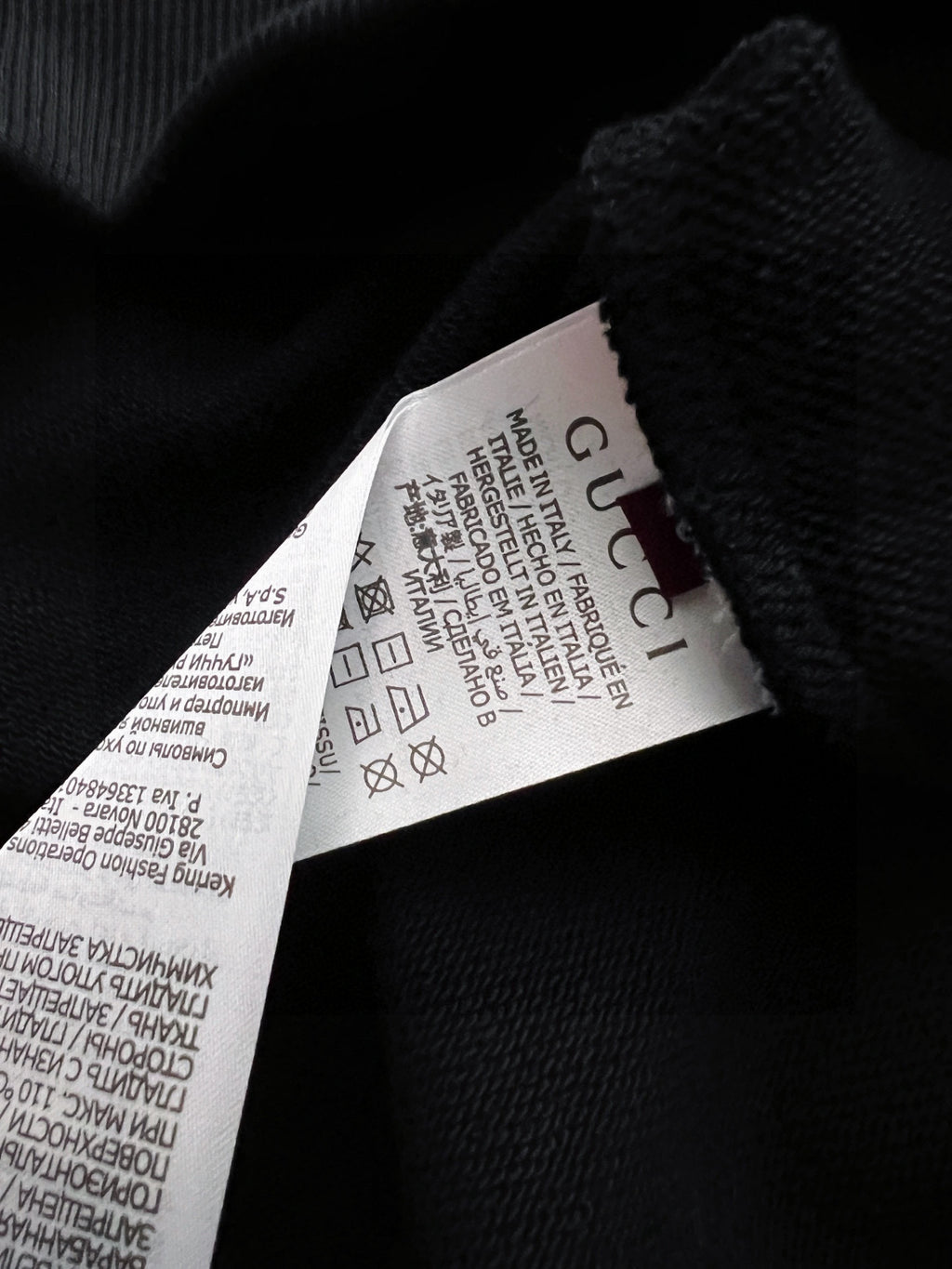 Black Gucci sweatshirt interior label on textured knit fabric