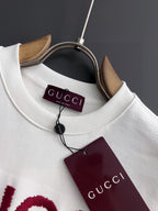 White Gucci sweatshirt with ribbed crew neck, Gucci label and maroon tag