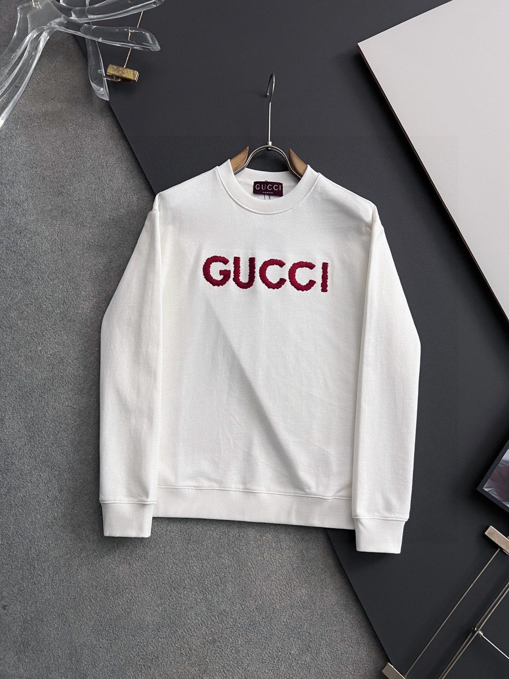White Gucci long-sleeve sweatshirt with red GUCCI logo at chest