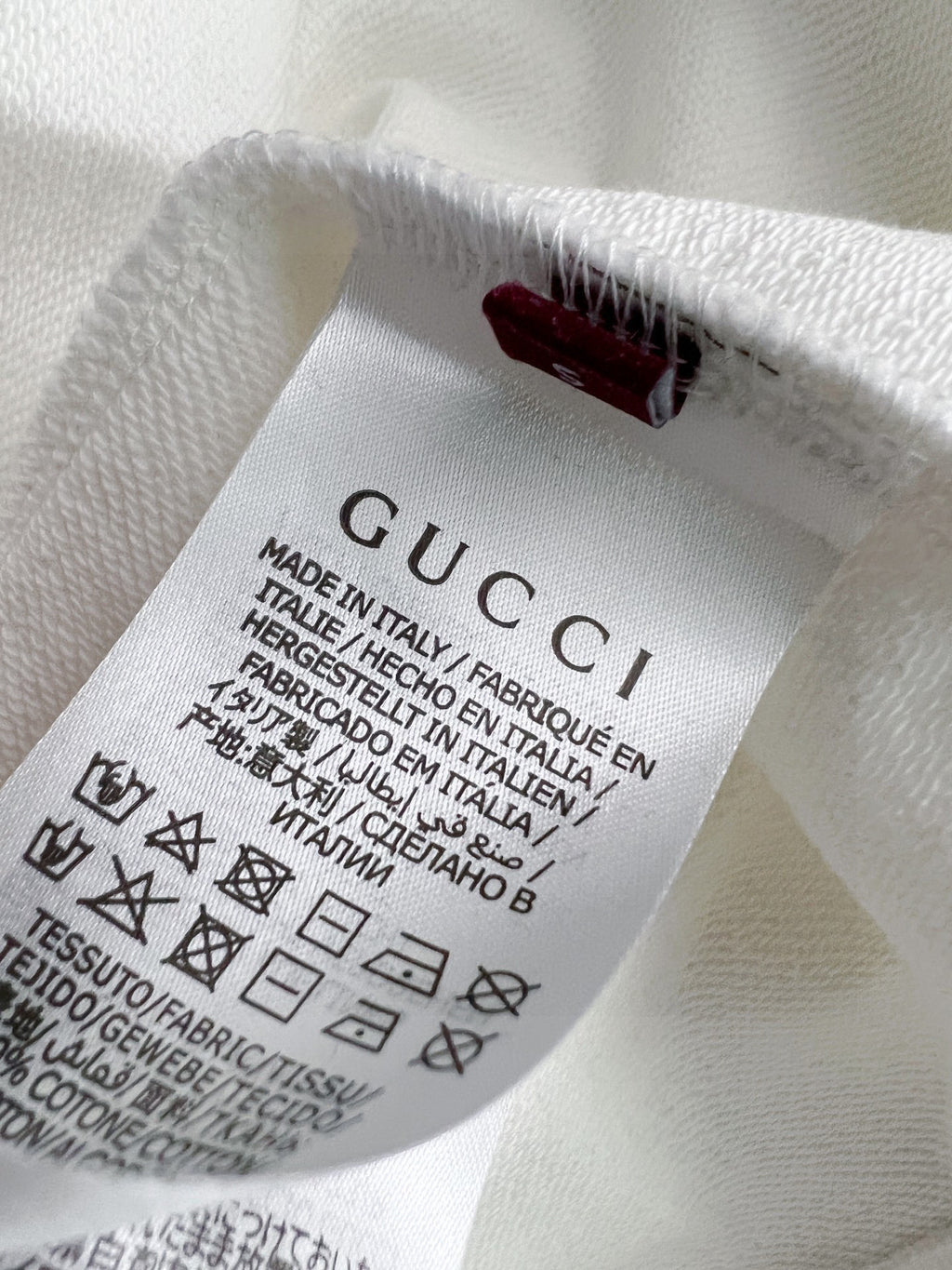 White sweatshirt inside neck with GUCCI fabric label and care text